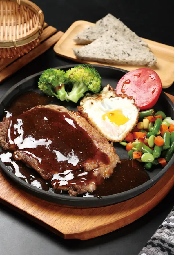 Sizzling New York Steak In Iron Plate